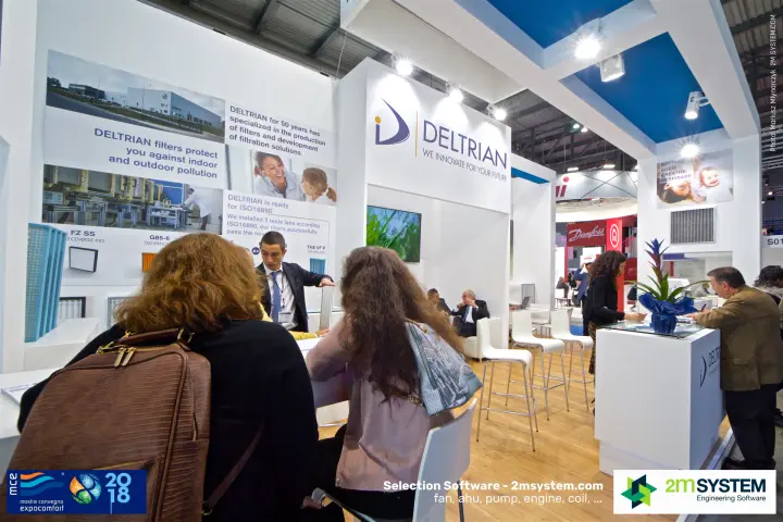 Visitors at a Deltrian table in front of the filter range wall