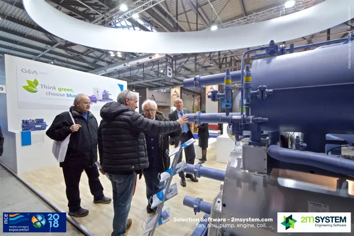 Visitors discussing a large blue GEA compressor package at MCE 2018