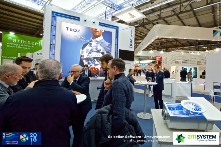 Visitors in discussion at the TROX stand by a swirl diffuser display at MCE 2018