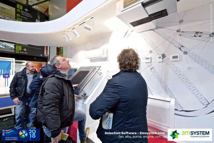Visitors examining a General ceiling cassette and wall controllers