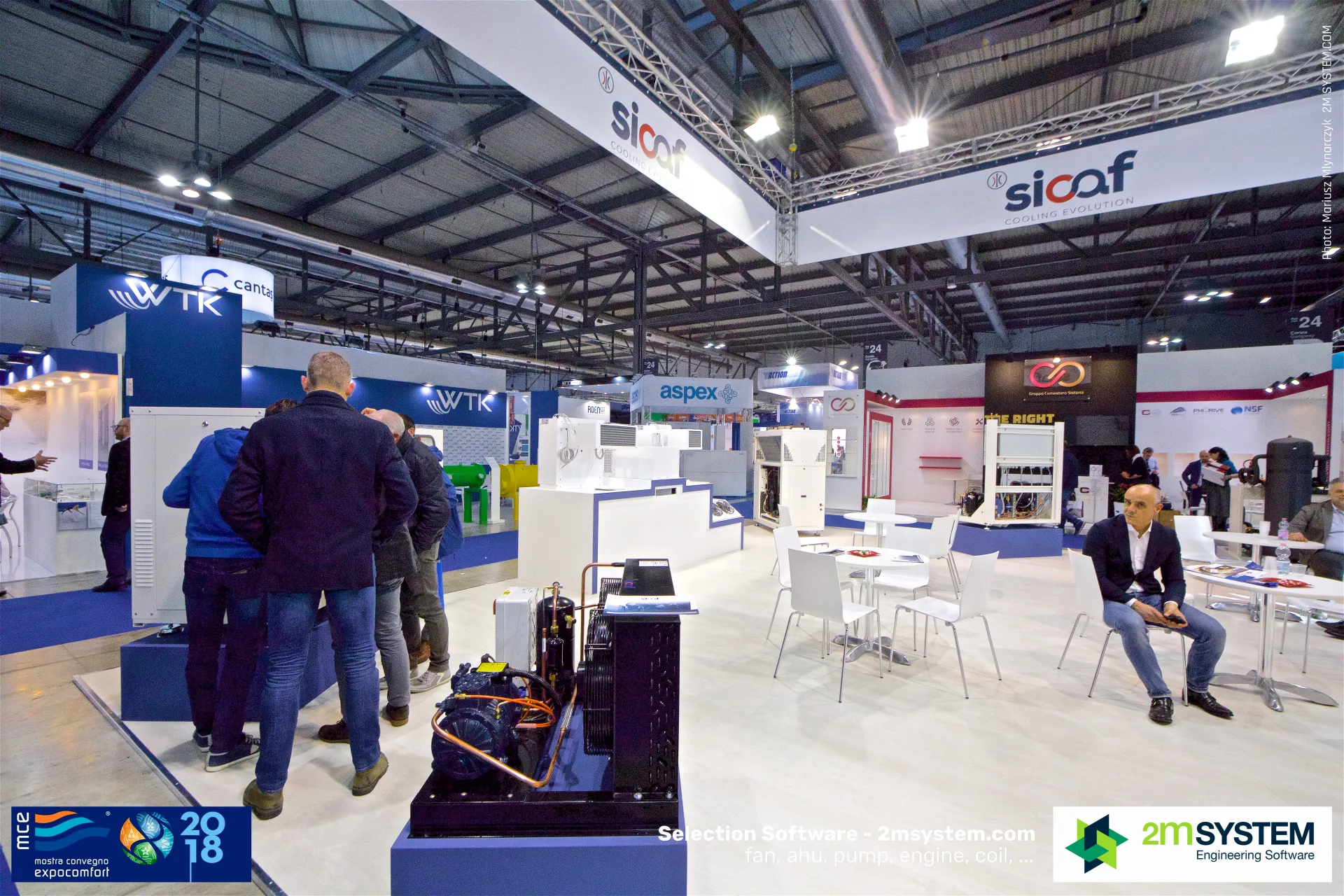 Visitors inspect a Sicaf unit beside a black condensing unit on display at MCE 2018