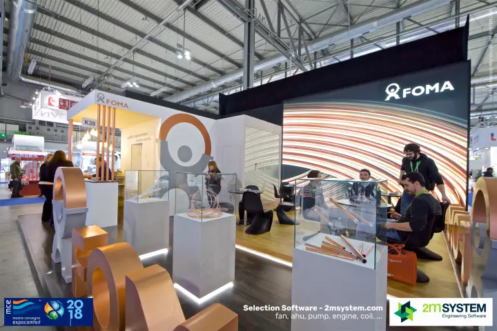 Visitors seated in the FOMA lounge behind copper tube showcases at MCE 2018