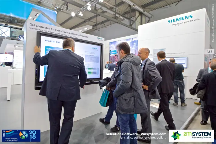 Visitors at the Siemens touchscreen on data-driven business optimization at MCE 2018