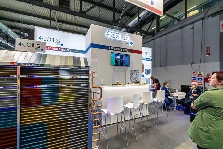 4Coils Tech coil sample with coloured fin coatings in front of the stand