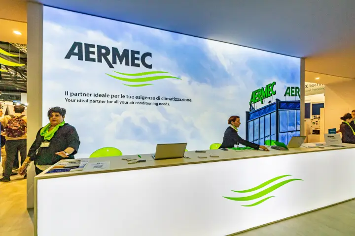 Aermec reception desk in front of a backlit sky graphic at MCE 2024