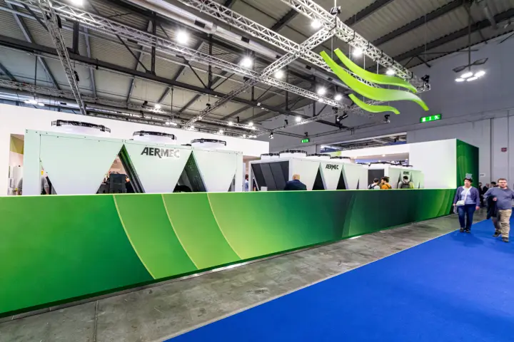 Aermec stand with large air-cooled units behind a green perimeter wall at MCE 2024