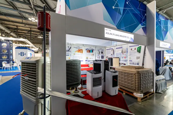 Aolan evaporative air coolers and a ceiling fan blade at booth T49 at MCE 2024