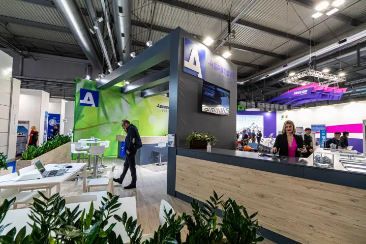 Aspirnova Industry lounge tables and wood-faced reception counter at MCE 2024
