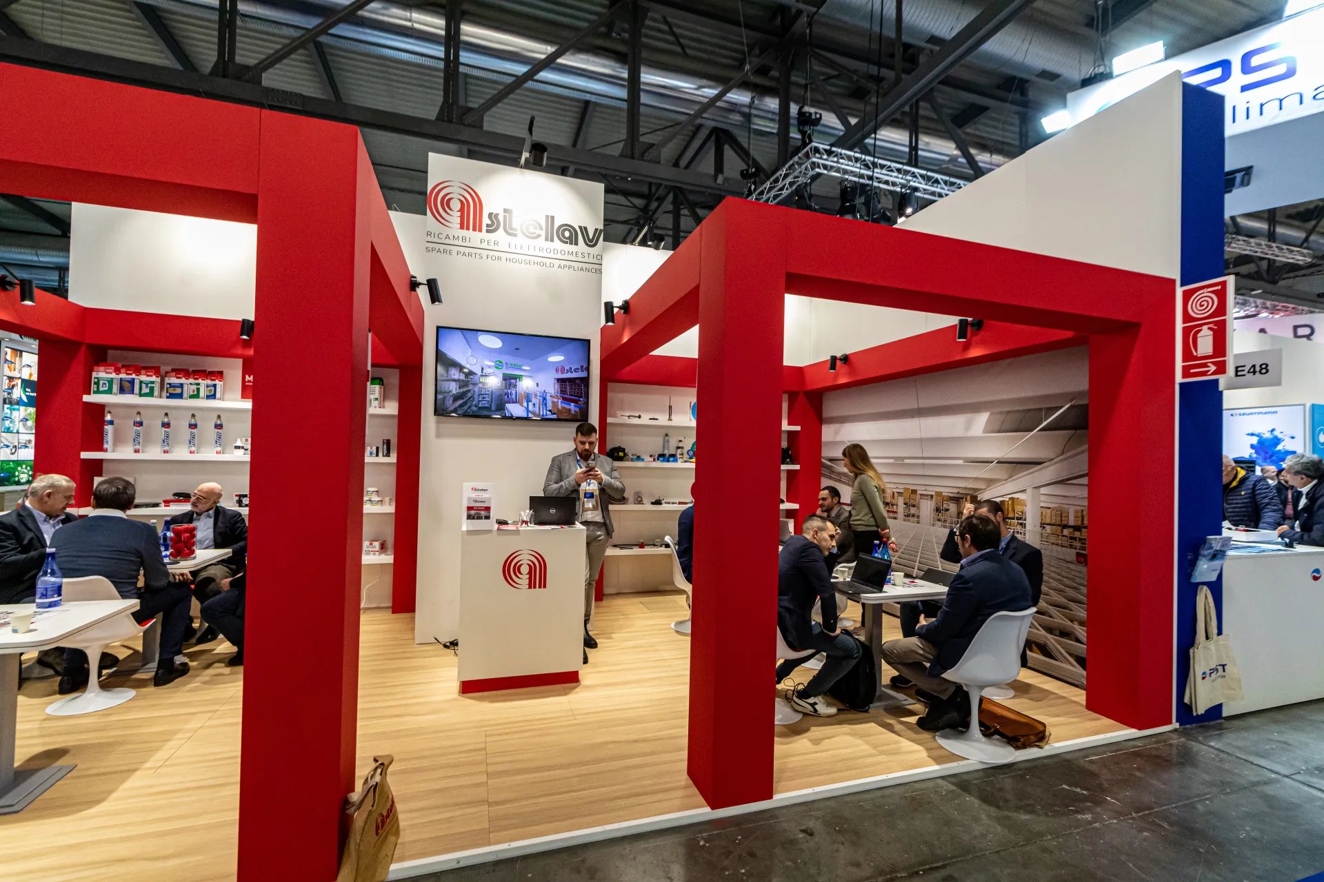 Astelav stand with red portal frames and busy meeting tables at MCE 2024