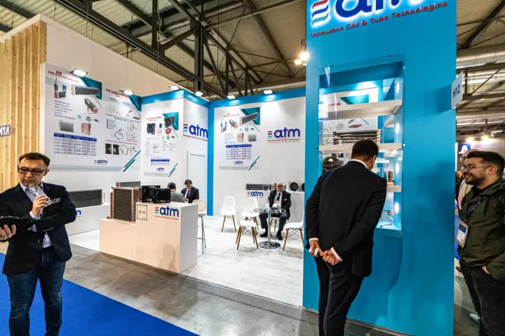 ATM Coil & Tube Technologies stand with illuminated logo tower at MCE 2024
