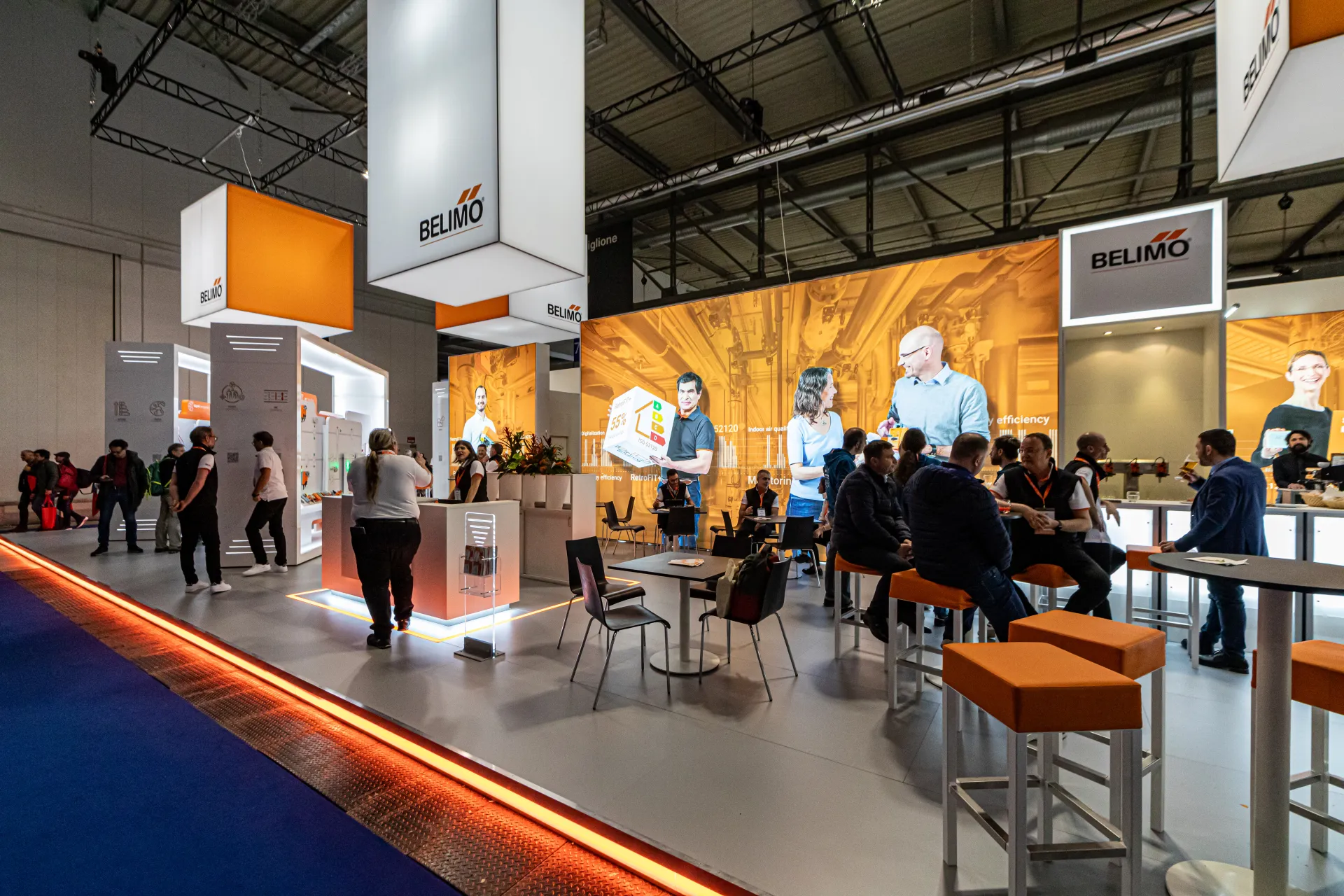 Belimo lounge and bar under backlit orange graphics at MCE 2024