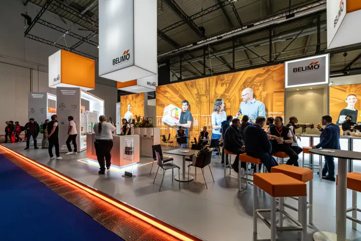 Belimo lounge and bar under backlit orange graphics at MCE 2024