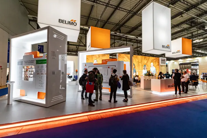 Belimo stand with backlit display frames and hanging logo cubes at MCE 2024