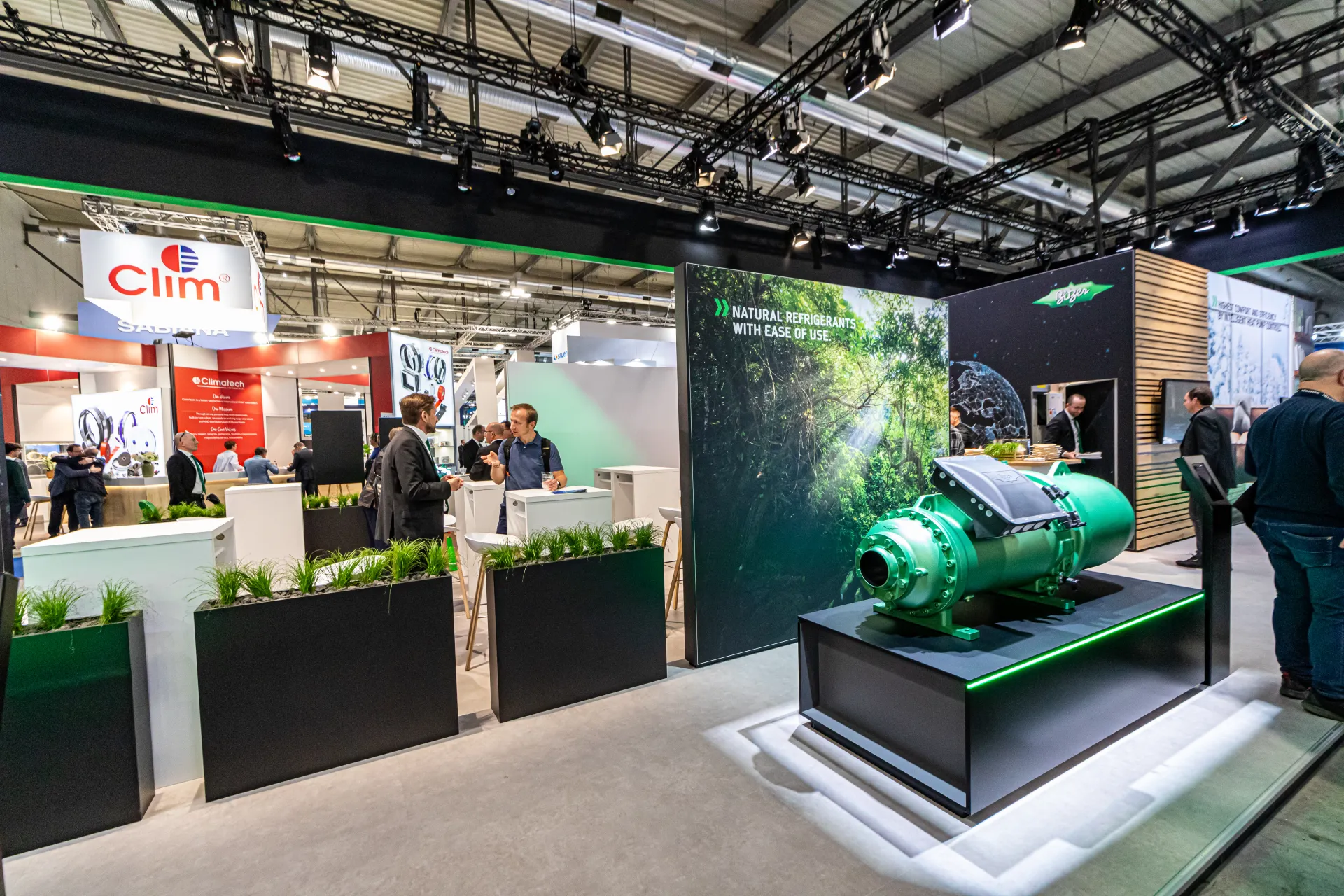 Bitzer screw compressor on a lit plinth beside the natural refrigerants wall at MCE 2024