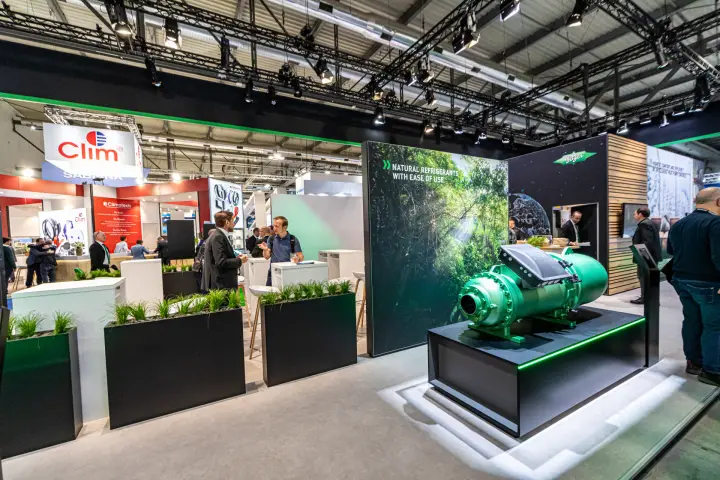 Bitzer screw compressor on a lit plinth beside the natural refrigerants wall at MCE 2024