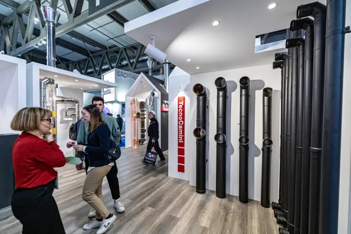 Black painted flue pipes and elbows on a TecnoCamini display wall