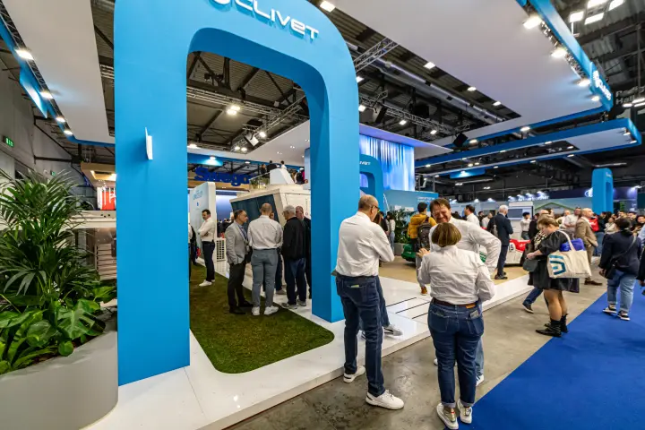 Blue arched entrance with Clivet logo leading onto a grass-floored stand at MCE 2024