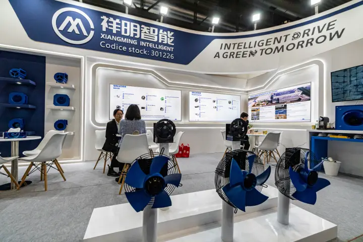 Blue-bladed axial fans in front of Xiangming Intelligent motor panels