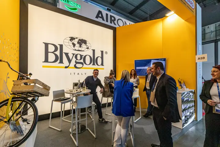 Blygold Italy stand with backlit logo wall and high tables
