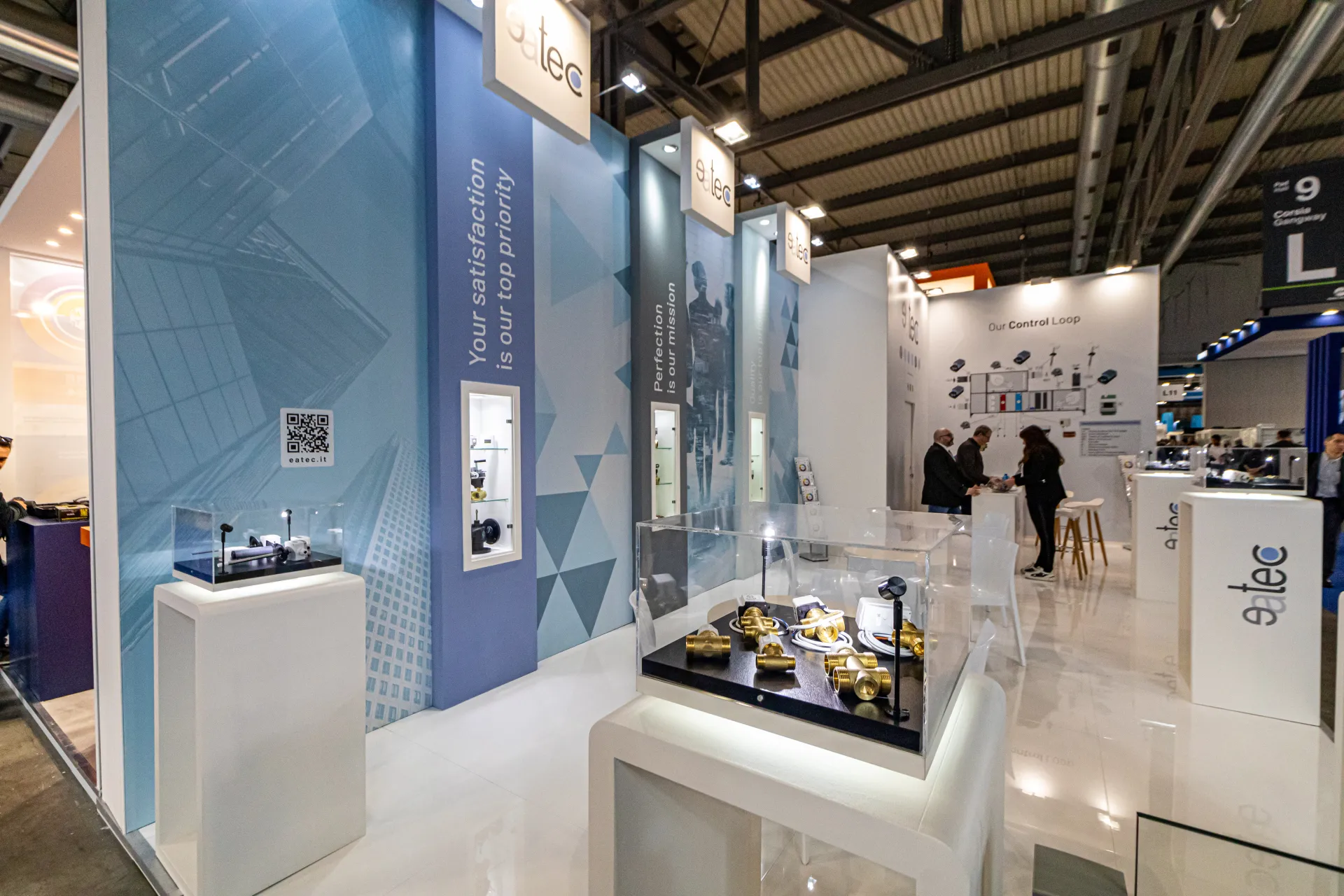 Brass valves and actuators in a glass case at the Eatec stand at MCE 2024