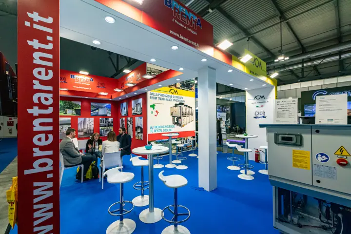 Brenta Rent meeting area with a wall of rental chiller photos at MCE 2024