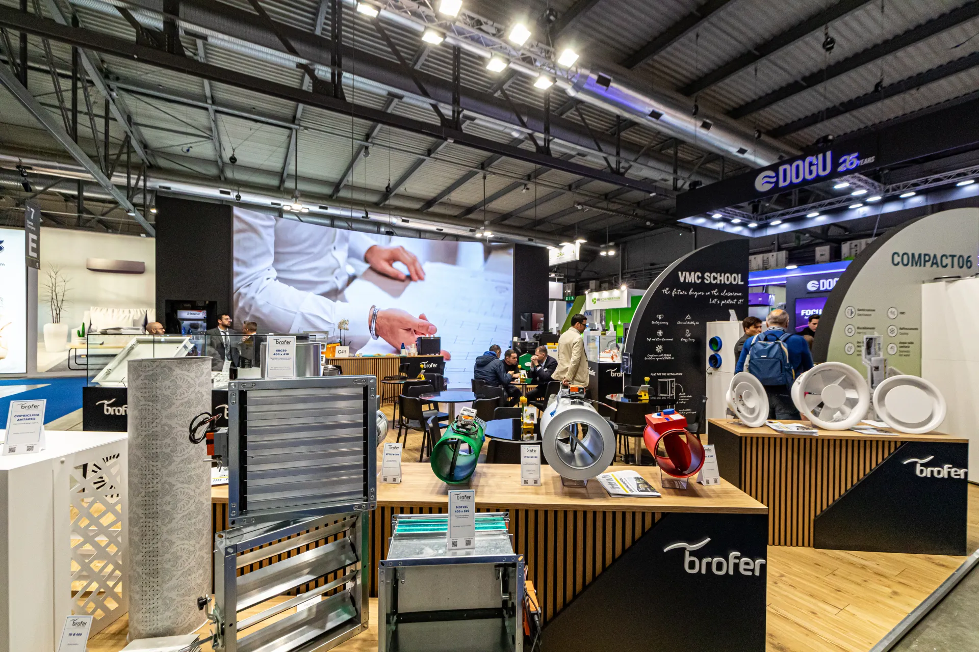 Brofer dampers and coloured inline duct fans with 'VMC SCHOOL' arch behind at MCE 2024