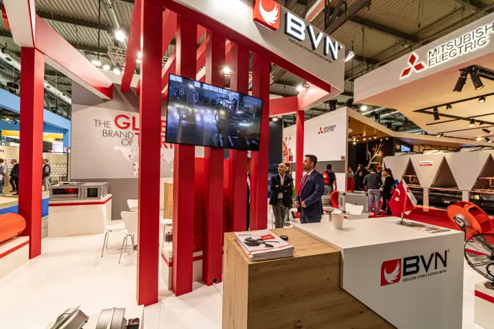 BVN wood and white counter with fan brochures under red columns at MCE 2024