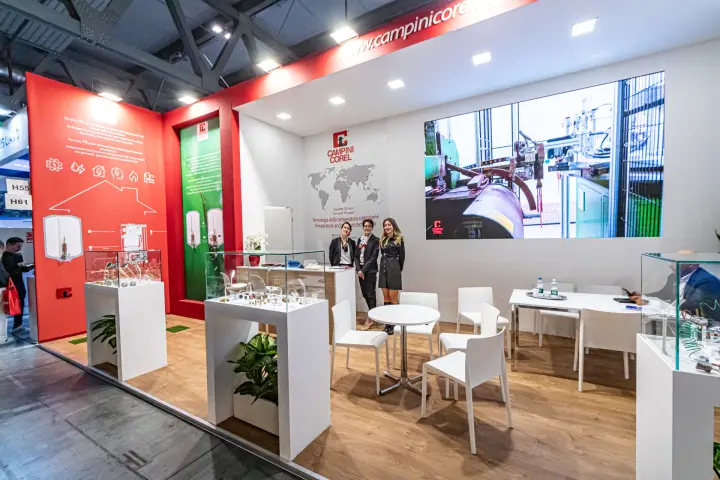Campini Corel stand with glass showcases and factory video wall