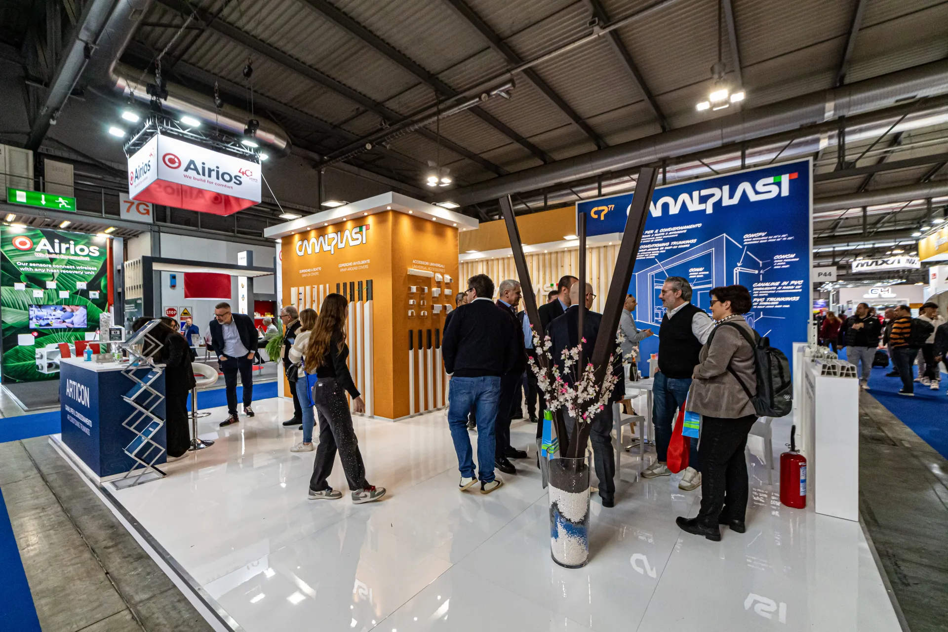 Canalplast stand with orange product tower and blue trunking display wall at MCE 2024