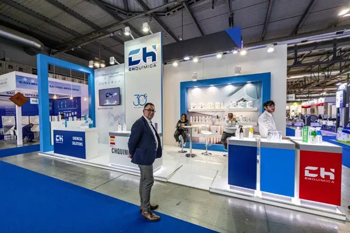 CHQuímica stand with chemical solutions and red and blue branded counters at MCE 2024