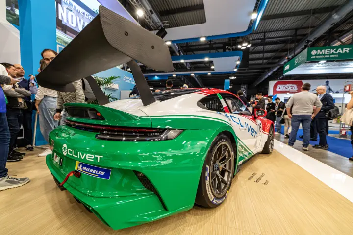 Clivet-liveried Porsche race car in green, white and red on the stand at MCE 2024