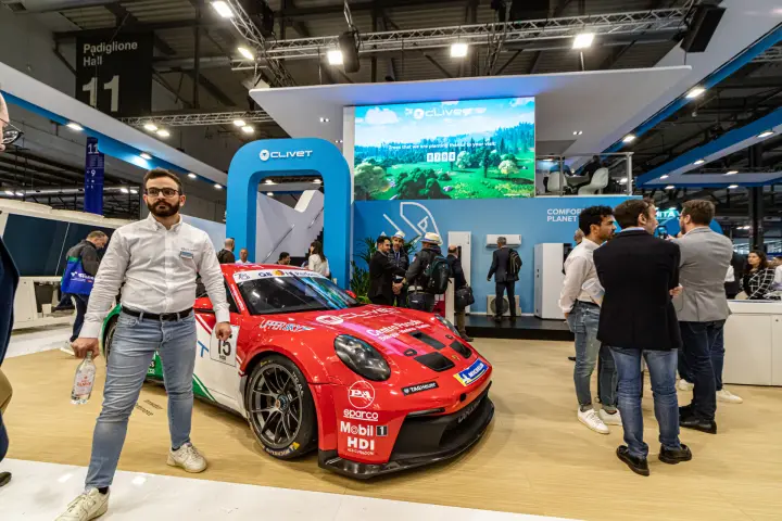 Clivet stand with a liveried race car and a tree-counter LED screen at MCE 2024