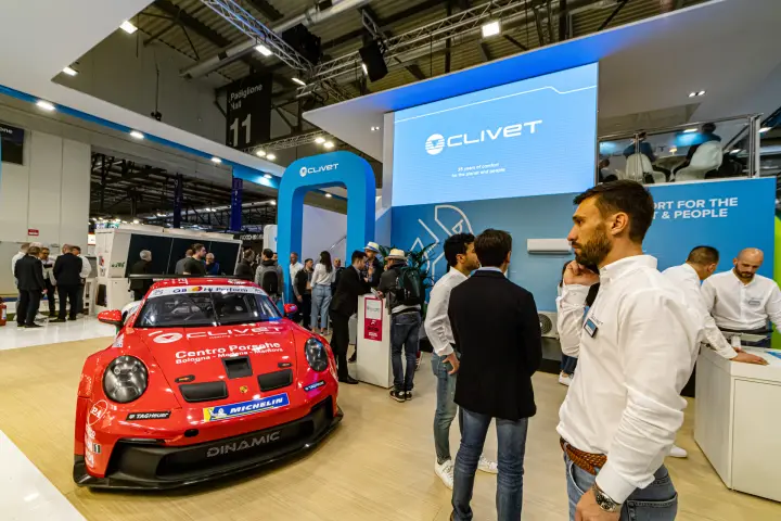 Clivet stand with red Porsche race car and '35 years of comfort' video wall at MCE 2024