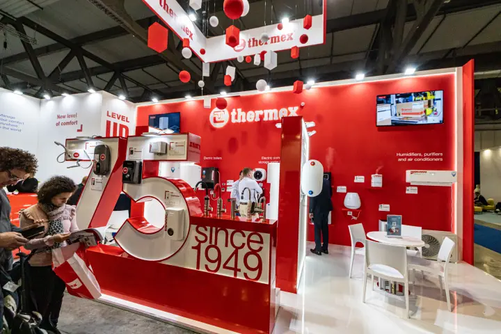 Close view of the Thermex '75 since 1949' display with water heaters and taps