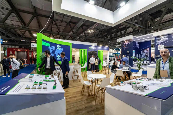 Cotherm stand with thermostat display tables and green slatted features at MCE 2024