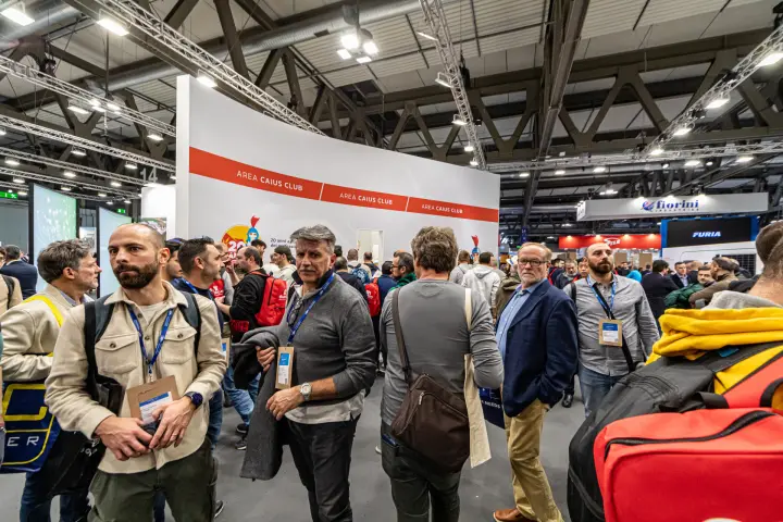 Crowd of visitors in front of the Area Caius Club wall at MCE 2024