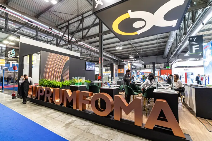 Cuprumfoma stand with large copper-finish lettering along the aisle at MCE 2024