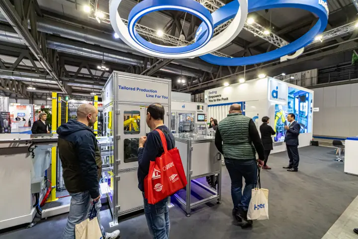 Dading Intell automated assembly cells under suspended blue rings at MCE 2024