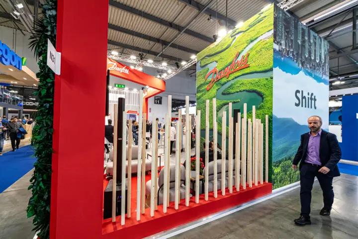 Danfoss lounge behind wooden slats and Shift landscape graphics at MCE 2024