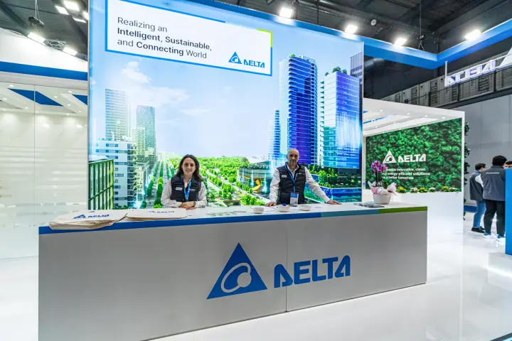 Delta Electronics reception counter with smart city backdrop at MCE 2024