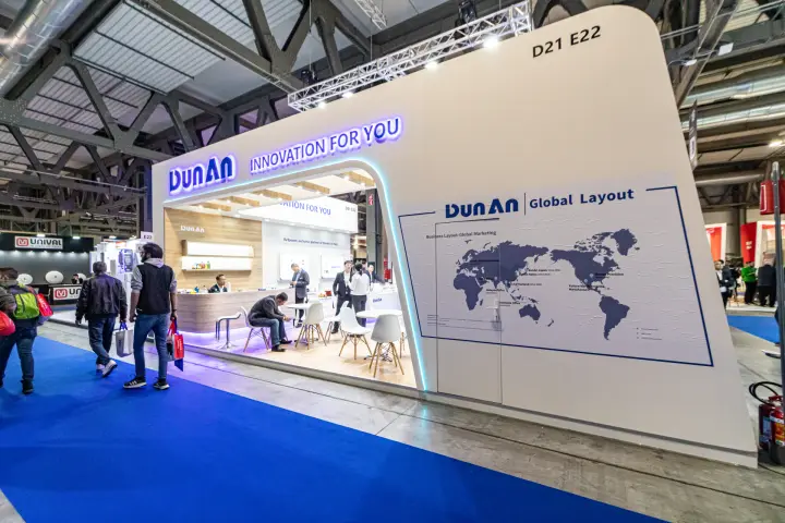DunAn stand with backlit slogan and global layout world map at MCE 2024