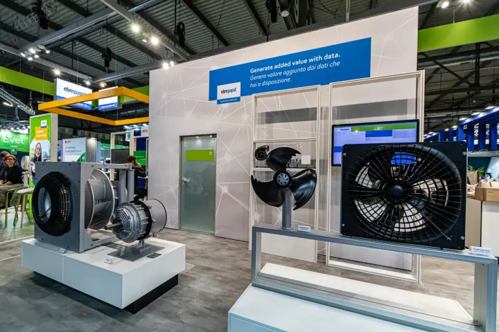 ebm-papst stand with centrifugal and axial fans before a data-themed wall at MCE 2024