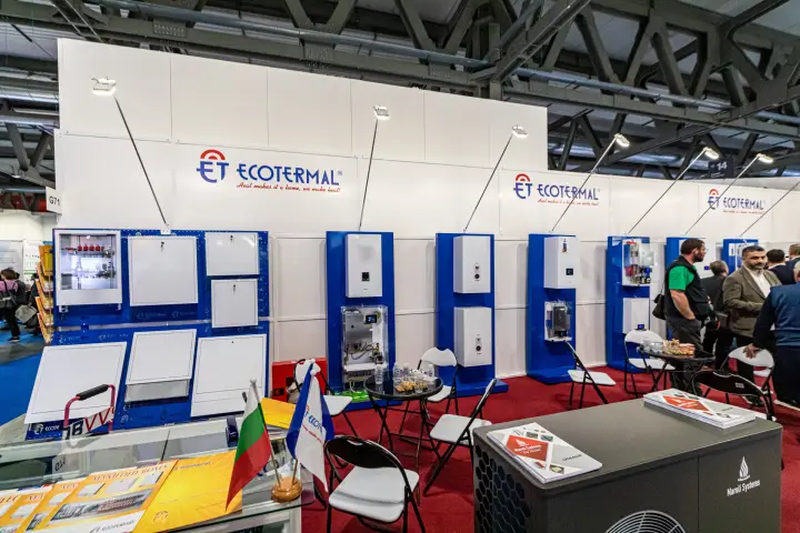Ecotermal stand with wall-hung boilers and manifold cabinets on blue panels at MCE 2024