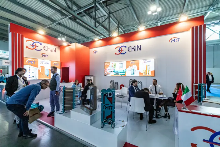 Ekin and MIT stand with teal plate heat exchangers on white plinths at MCE 2024