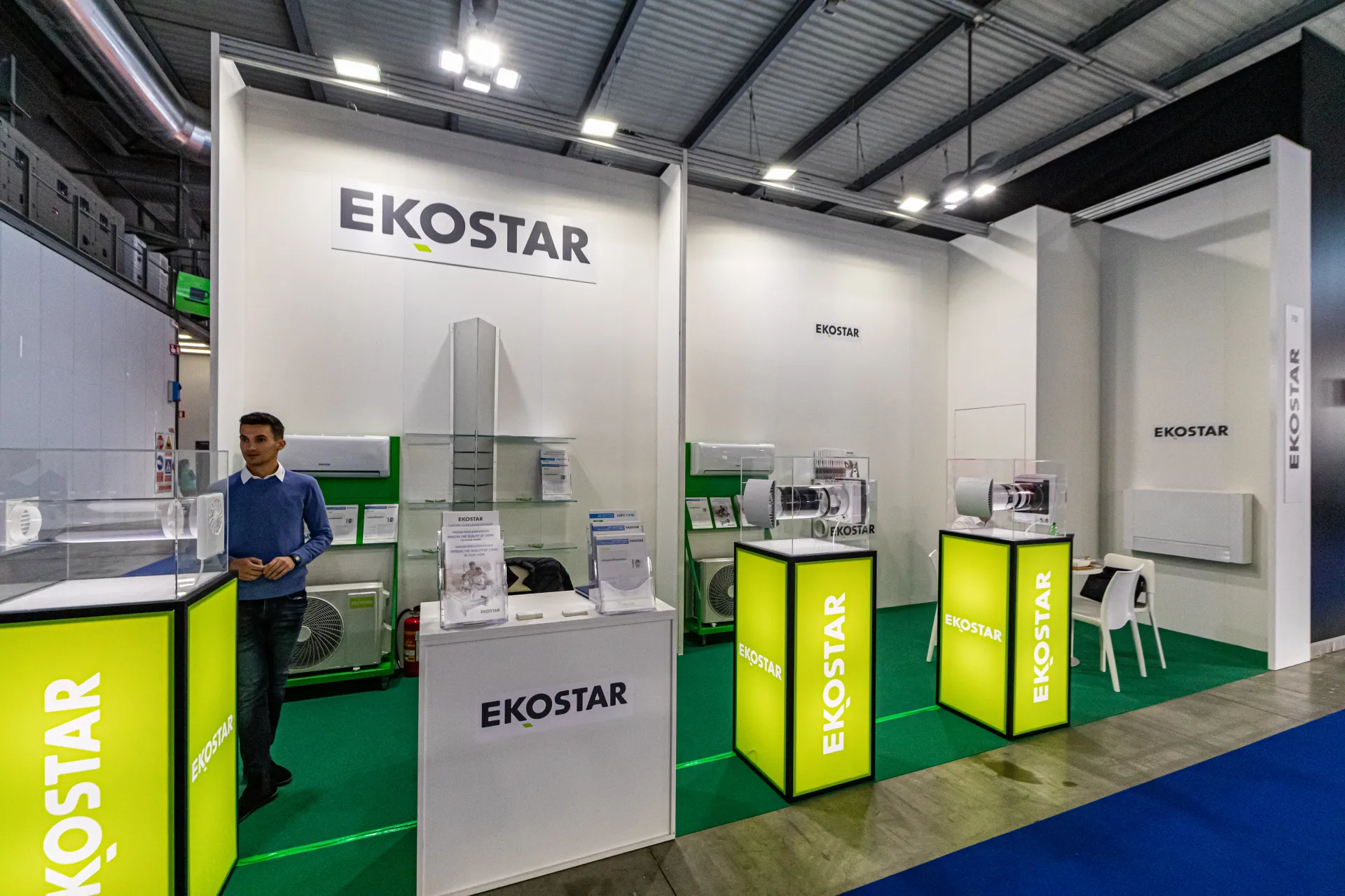Ekostar stand with split air conditioners and lit lime-green plinths at MCE 2024
