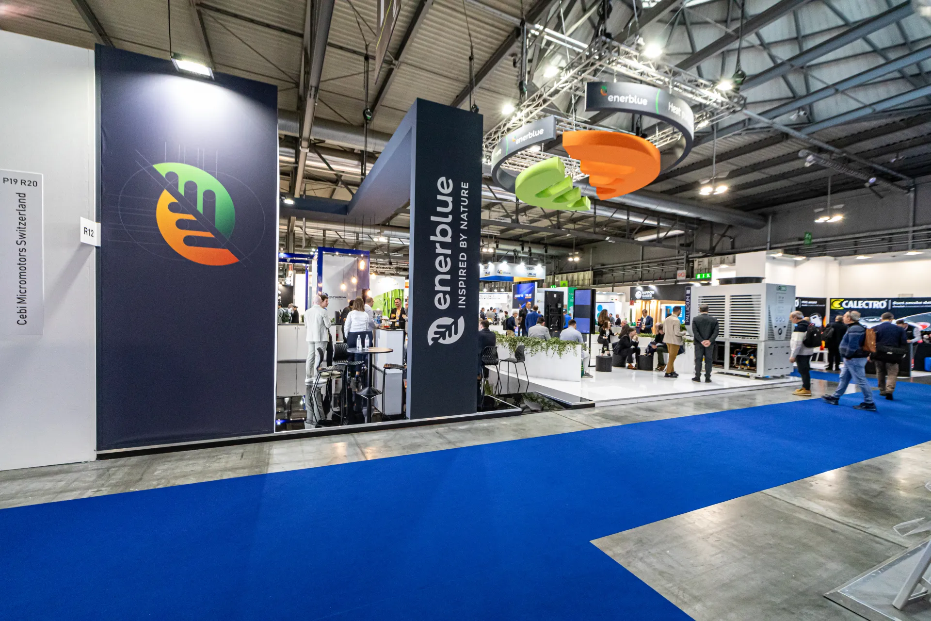 Enerblue stand with suspended ring banner and navy logo towers at MCE 2024
