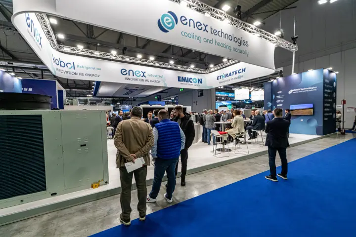Enex Technologies stand with group-brand ring banner over busy lounge at MCE 2024