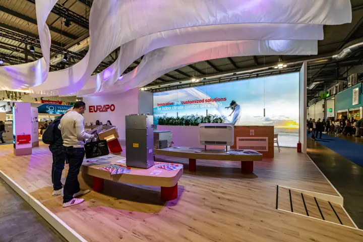 Eurapo fan coil units displayed on curved wooden plinths with red legs at MCE 2024