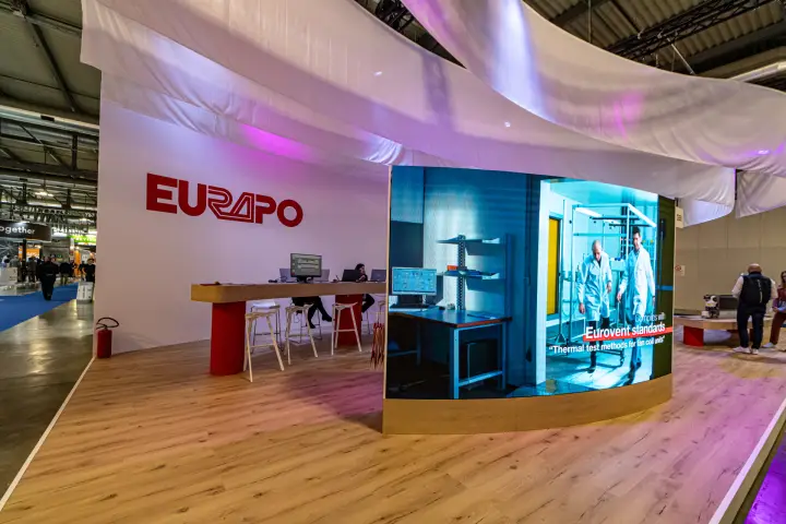 Eurapo stand with curved LED screen and long wooden reception counter at MCE 2024