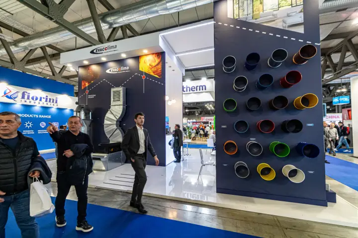 Evacclima stand with a wall of coloured spiral ducts and a fire-protection display at MCE 2024